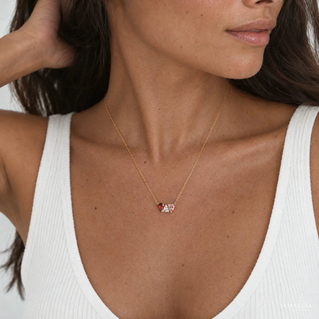 Woman wearing the ROSALIE necklace with three birthstones